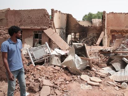 A man walks by a house hit in recent fighting in Khartoum, Sudan, on April 25, 2023.