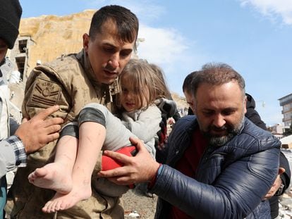 Muhammet Ruzgar, 5, is carried out by rescuers from the site of a damaged building, following an earthquake in Hatay, Turkey, February 7, 2023.