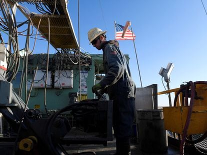 A worker operates equipment on a drilling rig near Midland, Texas, on February 12, 2019.