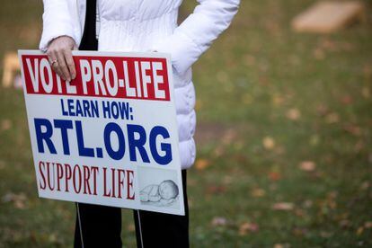 A woman holds an anti-abortion sign at a political event in Warren, Michigan, in 2020.