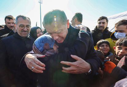 Turkish President Recep Tayyip Erdogan embraces a woman as he visits areas affected by the massive earthquake on the Turkish-Syrian border. 