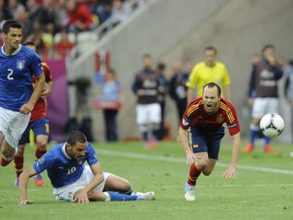 Andr&eacute;s Iniesta (right) feels the force of a tackle by Italy defender Leonardo Bonucci in Gdansk. 