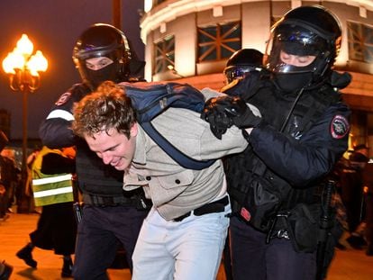 Police officers detain an anti-war protester in Moscow on Wednesday.