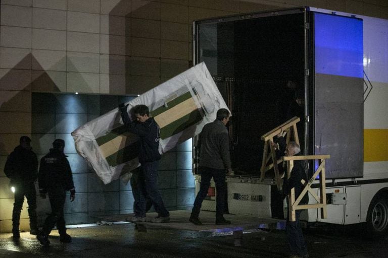 Workers unload a truck with the disputed treasures after the arrival of the Civil Guard.