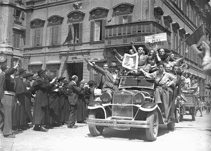 Catholic partisans hold up posters of Pope Pius XII during the liberation of Rome on June 4, 1944. 
