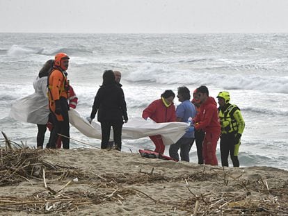 Authorities gather at the scene where bodies of migrants washed ashore following a shipwreck, at a beach near Cutro, Crotone province, on 26 February 2023.