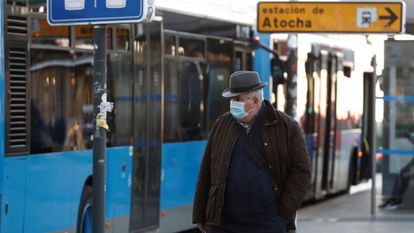 A man wears a mask outside Atocha train station in Madrid on Monday.