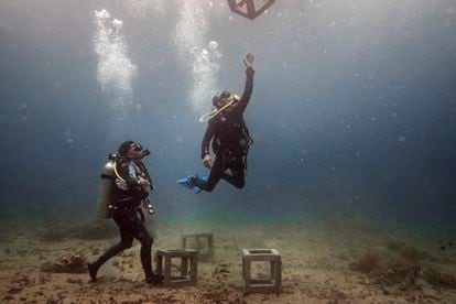 Divers in action. Two local divers place concrete pieces off the coast of Jameluk, east of Bali, which are part of a coral recovery project. Artificial structures can vary in materials and dimensions to create refuges for marine fauna.