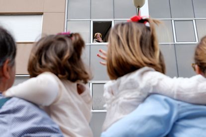 A grandmother waves to her granchildren from her home in Spain’s Canary Islands.