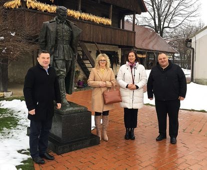 Kumrovec Mayor Robert Šplajt (left) poses with local business leaders and residents in front of the statue of former president Tito on January 17, 2023.