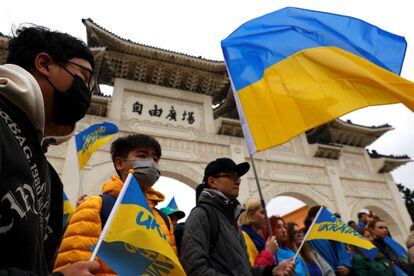 Protesters with Ukrainian flags at a rally in Taipei on February 25 to mark the first anniversary of the war.