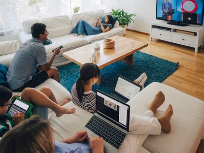 A family uses different technologies in their living room.