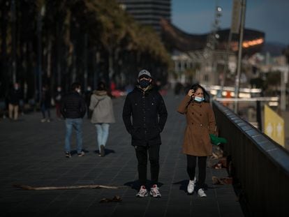 Passers-by wearing masks in Barcelona this week.