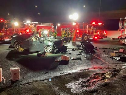 In this photo released by Contra Costa County Fire Protection District, firefighters work the scene of a fatal accident involving a Tesla and Contra Costa County fire truck early Saturday morning, Feb. 18, 2023, in Contra Costa, Calif.