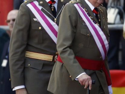 King Juan Carlos (r) and Prince Felipe attend a military event in El Escorial, outside Madrid, on Tuesday in their first public appearance together since the abdication announcement.