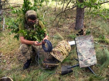 A Ukrainian soldier uses the Starlink satellite system during maneuvers in the Chernihiv region in June.