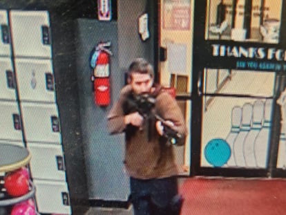 The unidentified gunman points a gun while entering Sparetime Recreation in Lewiston, Maine, on Oct. 25, 2023