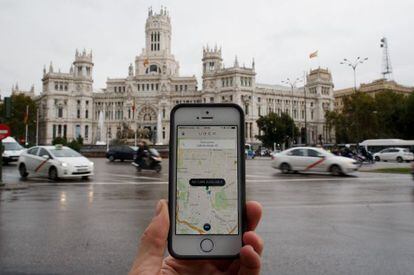 A smartphone running the Uber app in central Madrid.