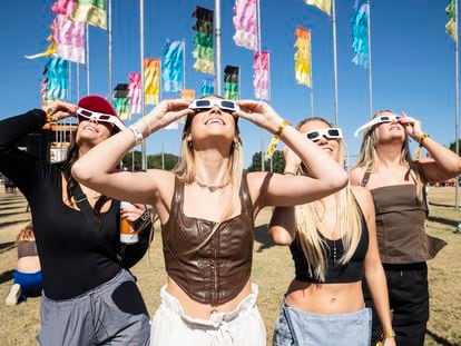 Women watch the October 14, 2023 solar eclipse at a music festival in Austin.