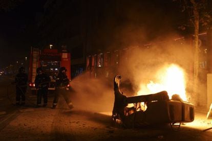 Protesters set a container on fire in Barcelona's Gràcia neighborhood.