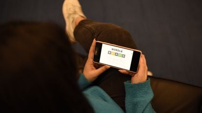 A user plays the English version of Wordle on his cell phone.