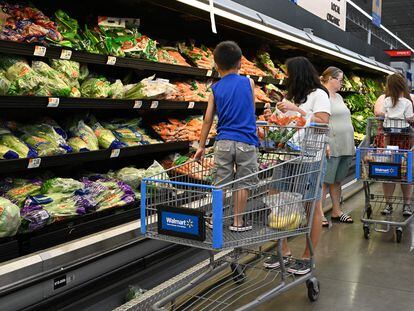 Consumers shop in the produce section of a Walmart store in Burbank, California, on August 15, 2022.