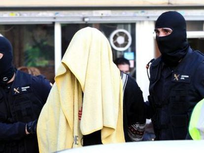 Civil guards escort the father of the family arrested in Badalona on Tuesday.