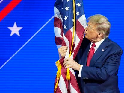 Former President Donald Trump kisses the American flag as he speaks at the Conservative Political Action Conference, CPAC 2024, at National Harbor, in Oxon Hill, Md., Feb. 24, 2024.