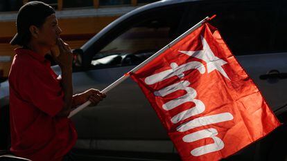 A supporter carries an FMLN flag during a campaign closing rally in San Salvador, January 27, 2024.