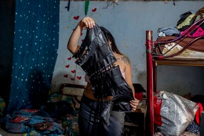 Juanita Prada, 43, holds a corset in Medellín.
