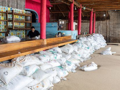 Sand bags are piled up in front of a bar to prevent flooding as Hurricane Norma barrels towards the Baja California peninsula, in Cabo San Lucas, Mexico, October 20, 2023.