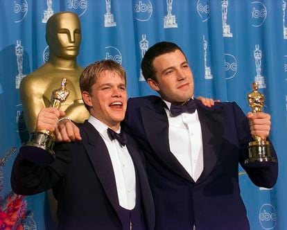 Winners Ben Affleck and Matt Damon hold their Oscar Awards backstage at Academy Awards Show, 1998