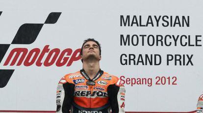 Honda rider Dani Pedrosa of Spain listens to the national anthem on the podium after winning the Malaysian MotoGP.