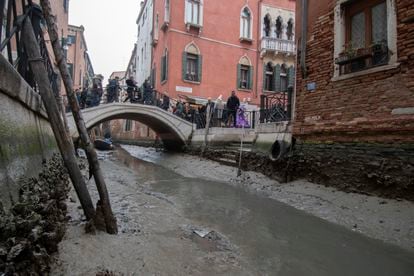A dried-up canal during a low tide in Venice, Italy, Tuesday, February 21, 2023.