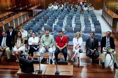 Isabel Pantoja (third from left) sits with other Operation Malaya defendants in a M&aacute;laga courtroom Thursday.