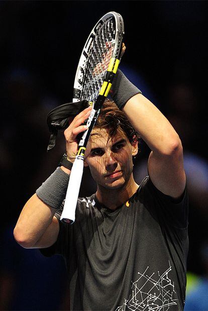 Nadal applauds the London crowd after beating Mardy Fish.