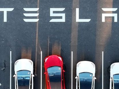 An aerial view shows cars parked at the Tesla Fremont Factory in Fremont, California, on February 10, 2022.