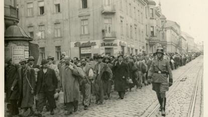 A German officer escorts a convoy of prisoners along a street in Tarnów, Poland, June 1940.