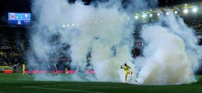 Villarreal&#039; s forward Jonathan Pereira kicks the teargas cannister thrown onto the field during the match against Villarreal.