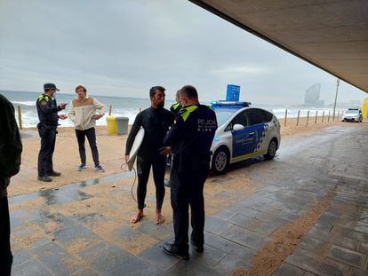 Police officers write up one of the surfers on Wednesday.