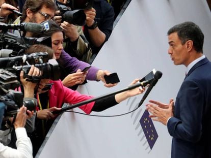 Pedro Sánchez talks to the media as he arrives at a European Union leaders summit.