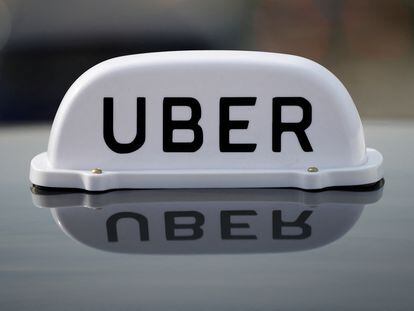 The Logo of taxi company Uber is seen on the roof of a private hire taxi in Liverpool, Britain, April 15, 2019.