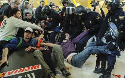 Strikers of Spanish airline Iberia clash with baton-wielding police at Madrid-Barajas airport on Monday.