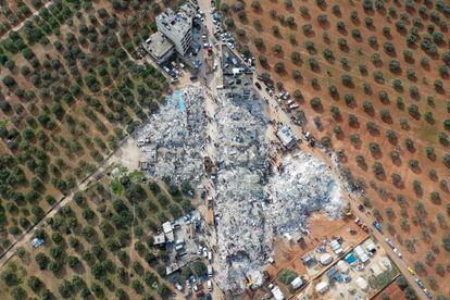 This aerial view shows residents searching for victims and survivors amidst the rubble of collapsed buildings following an earthquake in the village of Besnia near the town of Harim, in Syria's rebel-held northwestern Idlib province on the border with Turkey.
