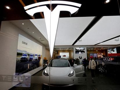 Visitors check a Tesla Model 3 car next to a Model Y displayed at a showroom of the U.S. electric vehicle (EV) maker in Beijing, China, on February 4, 2023.