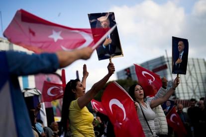 Supporters of Turkish President and People's Alliance's presidential candidate Recep Tayyip Erdogan give handouts to commuters in Istanbul, Turkey, on May 23, 2023.