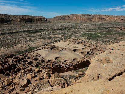 A hiker sits on a ledge above Pueblo Bonito, the largest archeological site at the Chaco Culture National Historical Park, in northwestern New Mexico, on Aug. 28, 2021.