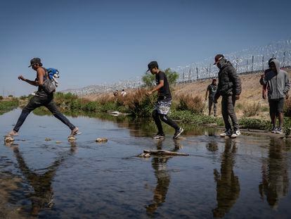 A group of migrants crosses the Rio Bravo in Ciudad Juarez, Mexico, on their way to the United States.