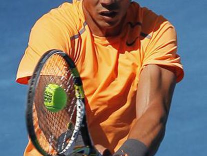 Nadal returns the ball on the new blue clay at the Madrid Open on Wednesday.
