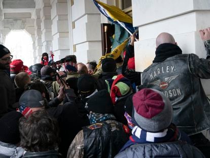 Insurrectionists loyal to President Donald Trump try to open a door of the U.S. Capitol as they riot in Washington, Jan. 6, 2021.